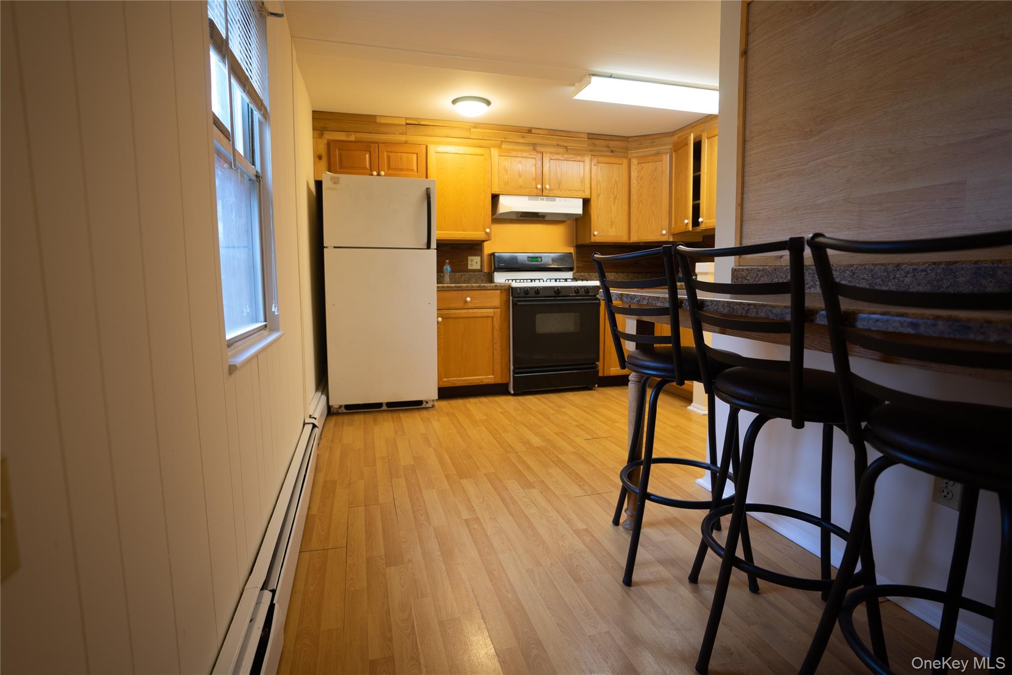 4 Jay Street Stony Point, NY 10980 - Photo 12 of 21 a kitchen with stainless steel appliances granite countertop a refrigerator a stove and a dining table with wooden floor