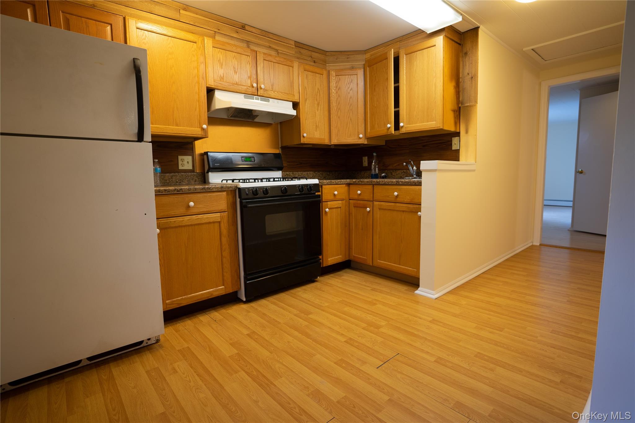 4 Jay Street Stony Point, NY 10980 - Photo 13 of 21 a kitchen with granite countertop a refrigerator stove and wooden floor