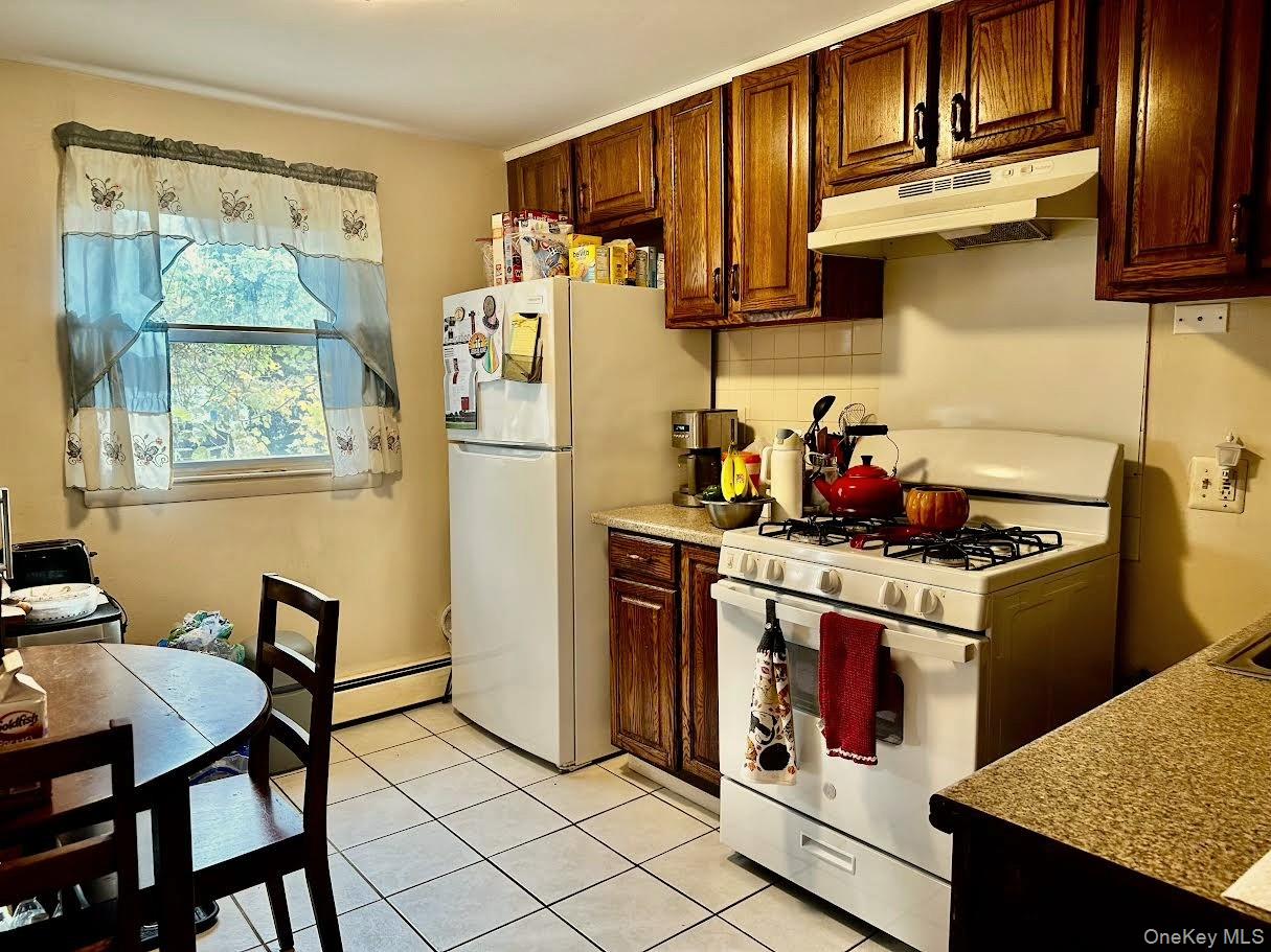 4 Jay Street Stony Point, NY 10980 - Photo 17 of 21 a kitchen with stainless steel appliances granite countertop a stove refrigerator sink and cabinets