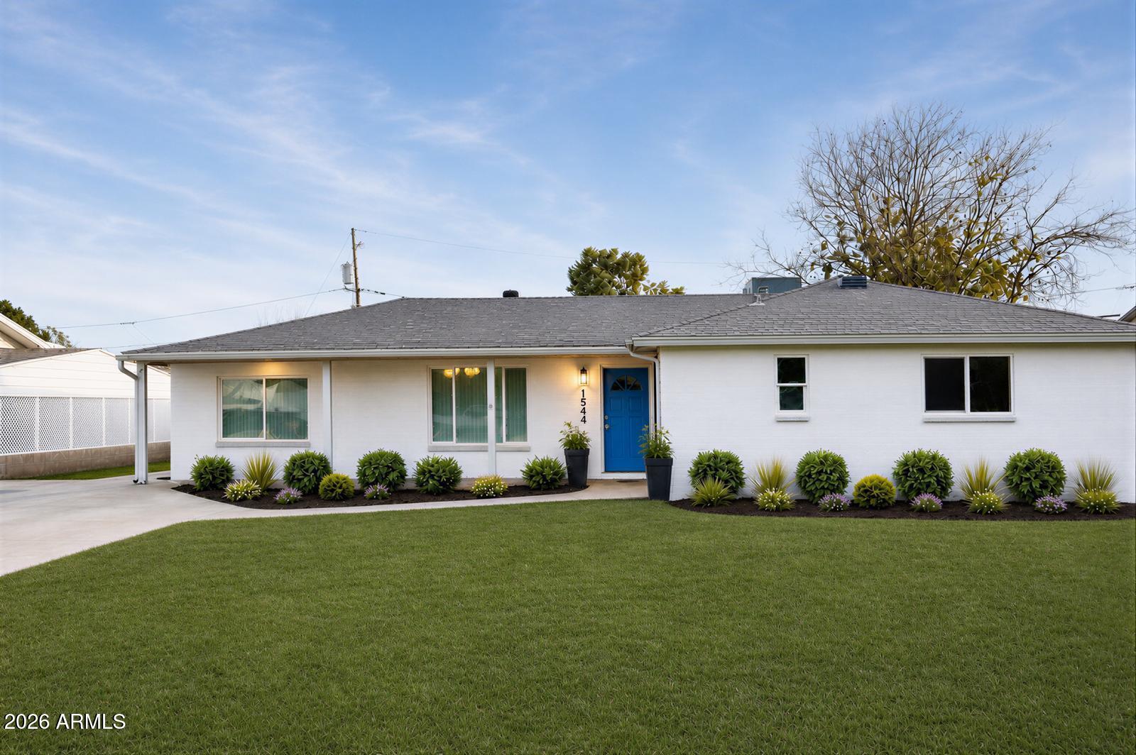 a front view of a house with garden