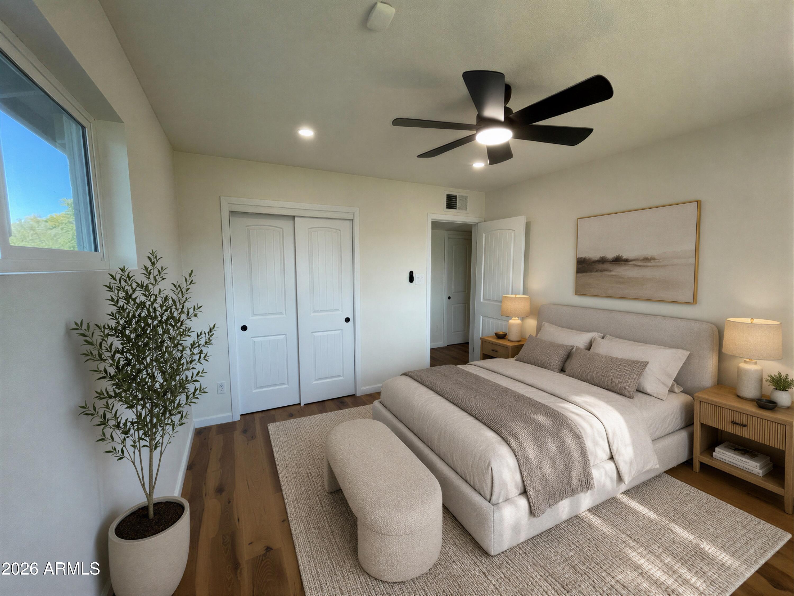 1819 West Morten Avenue Phoenix, AZ 85021 - Photo 11 of 15 a spacious bedroom with a large bed and a potted plant