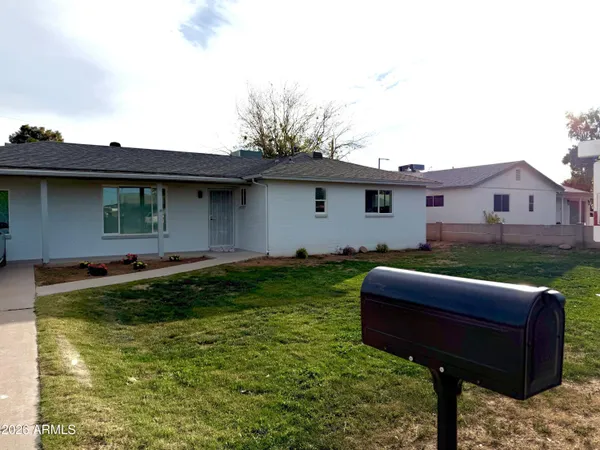 a front view of house with yard and outdoor seating