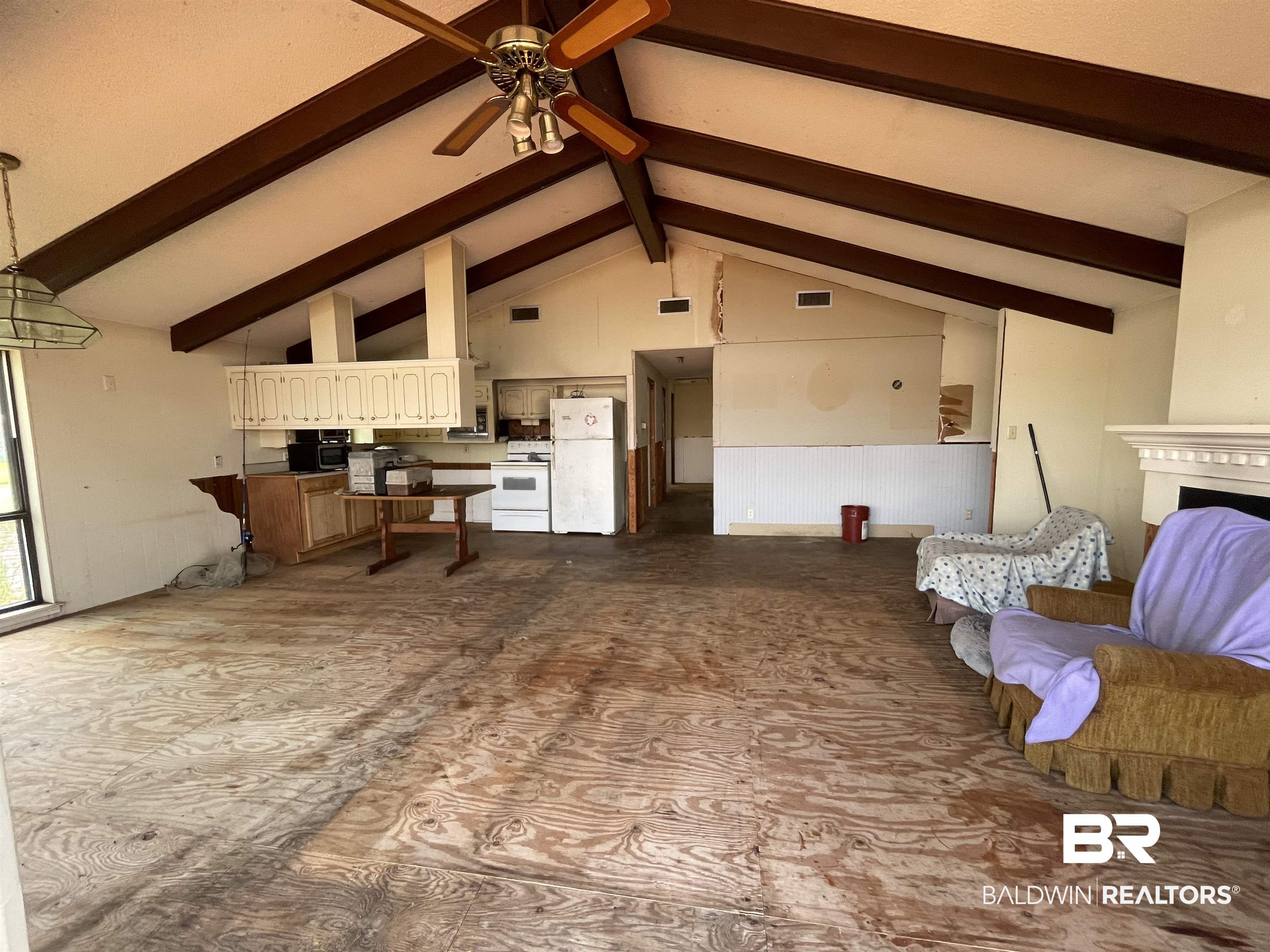 3074 Riverside Drive West Mobile, AL 36605 - Photo 6 of 15 Living room with high vaulted ceiling, beamed ceiling, and ceiling fan