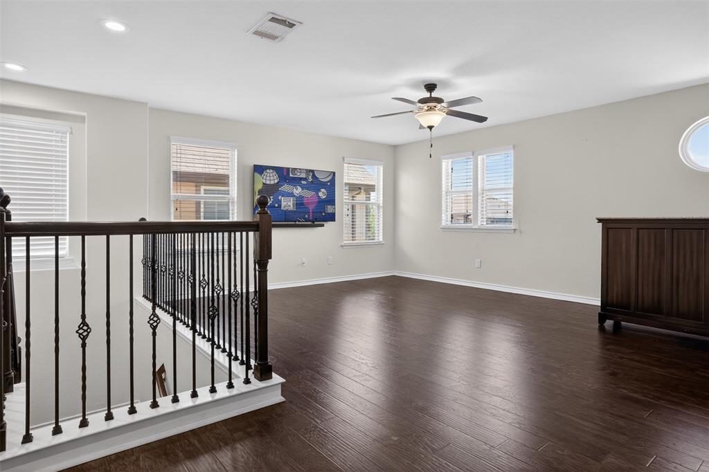 8728 Maple Ridge Trail Fort Worth, TX 76244 - Photo 7 of 40 Spacious upper-level area featuring dark wood-finish flooring and light-toned walls