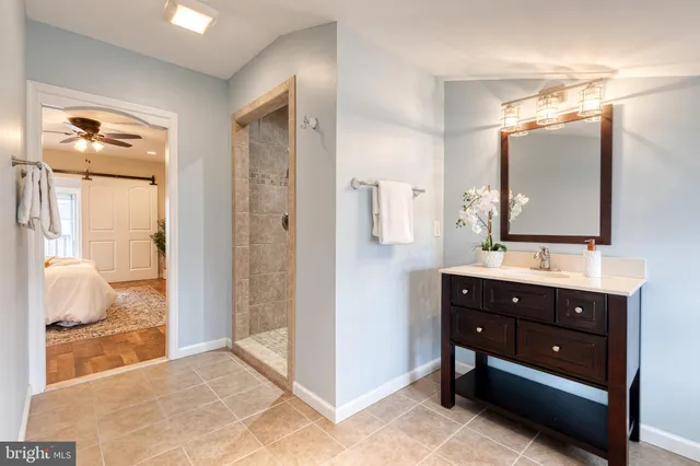 a bathroom with a sink vanity and a mirror