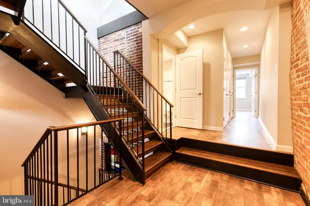 a view of staircase with lots of white walls and a window