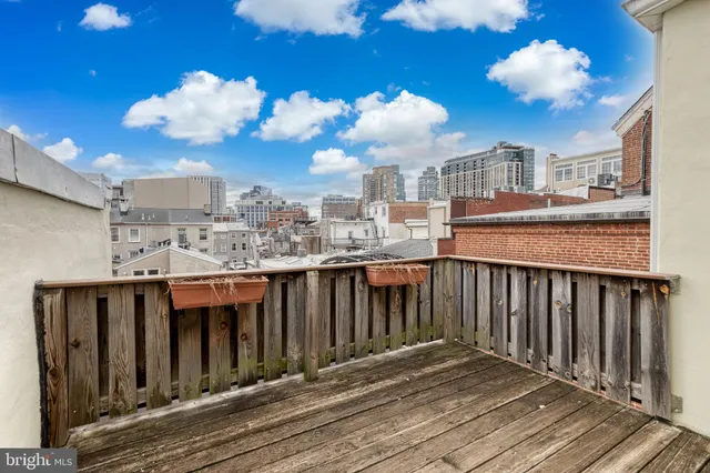 a view of a balcony with wooden floor