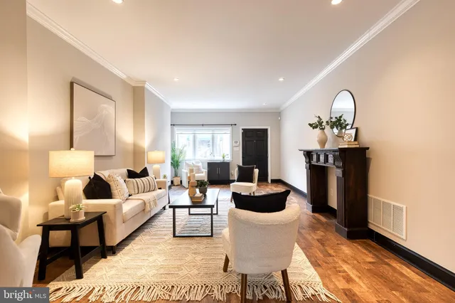 a living room with furniture a rug and a window