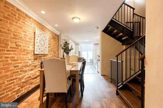 a view of a dining room with furniture and a chandelier