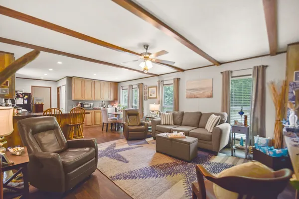 a living room with furniture ceiling fan and a rug