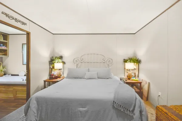 a bedroom with a bed and a chandelier