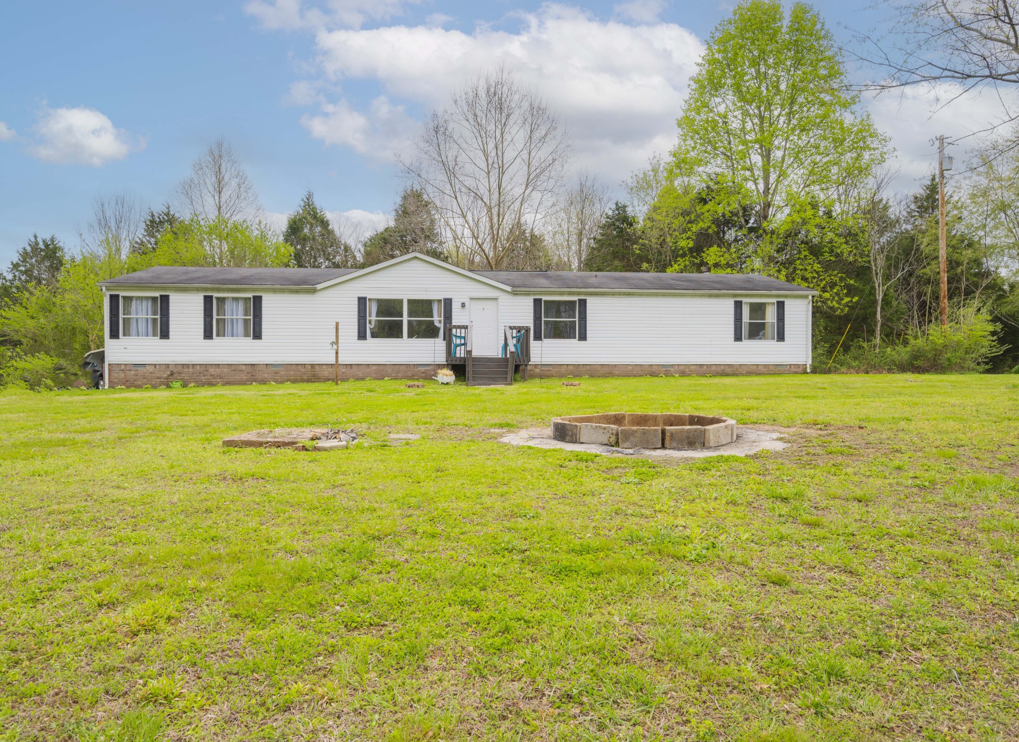 a view of a house with a swimming pool and a yard