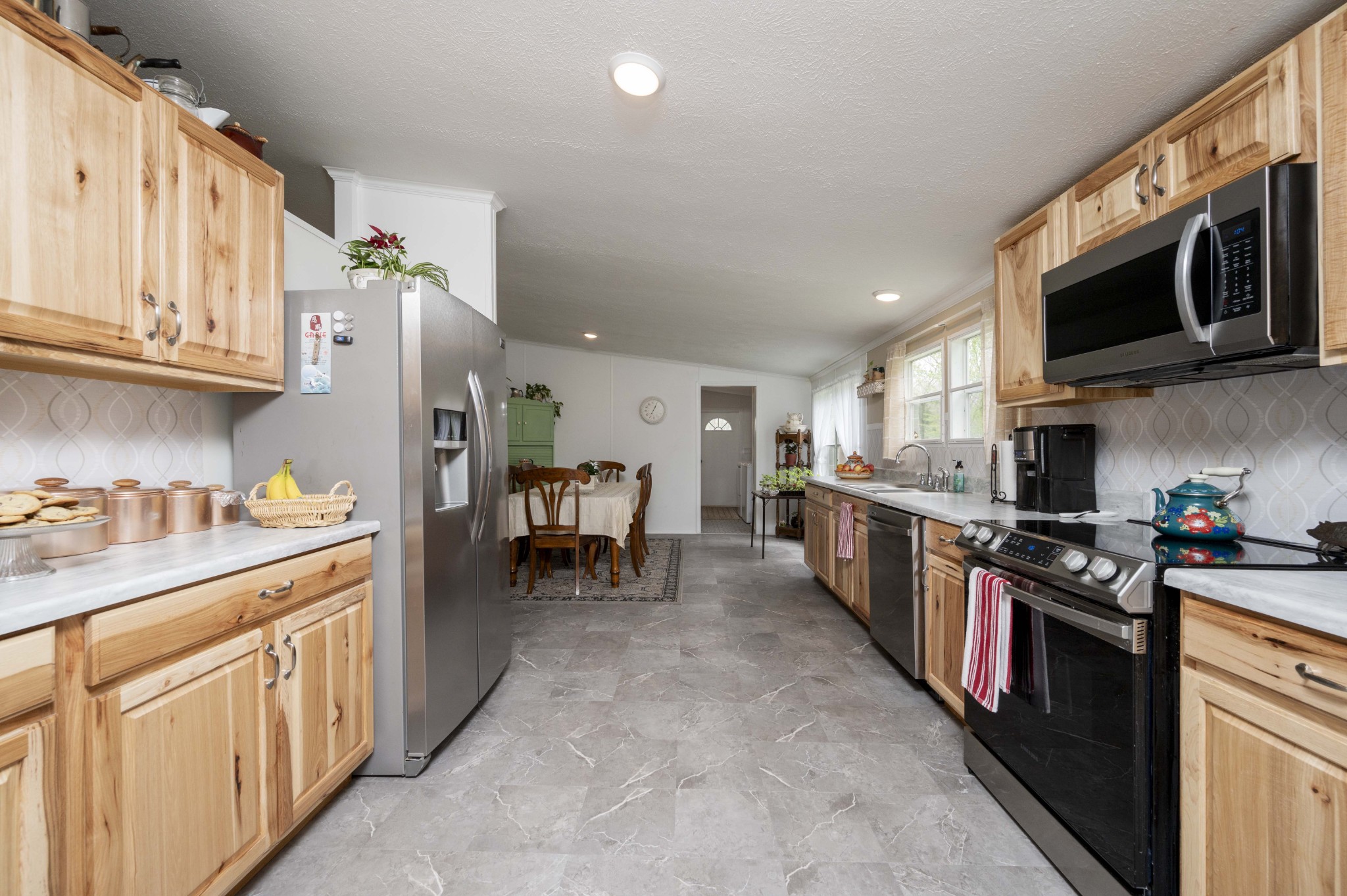 1822 Groveland Ridge Road Columbia, TN 38401 - Photo 16 of 48 a kitchen with stainless steel appliances granite countertop a stove top oven a sink dishwasher and white cabinets