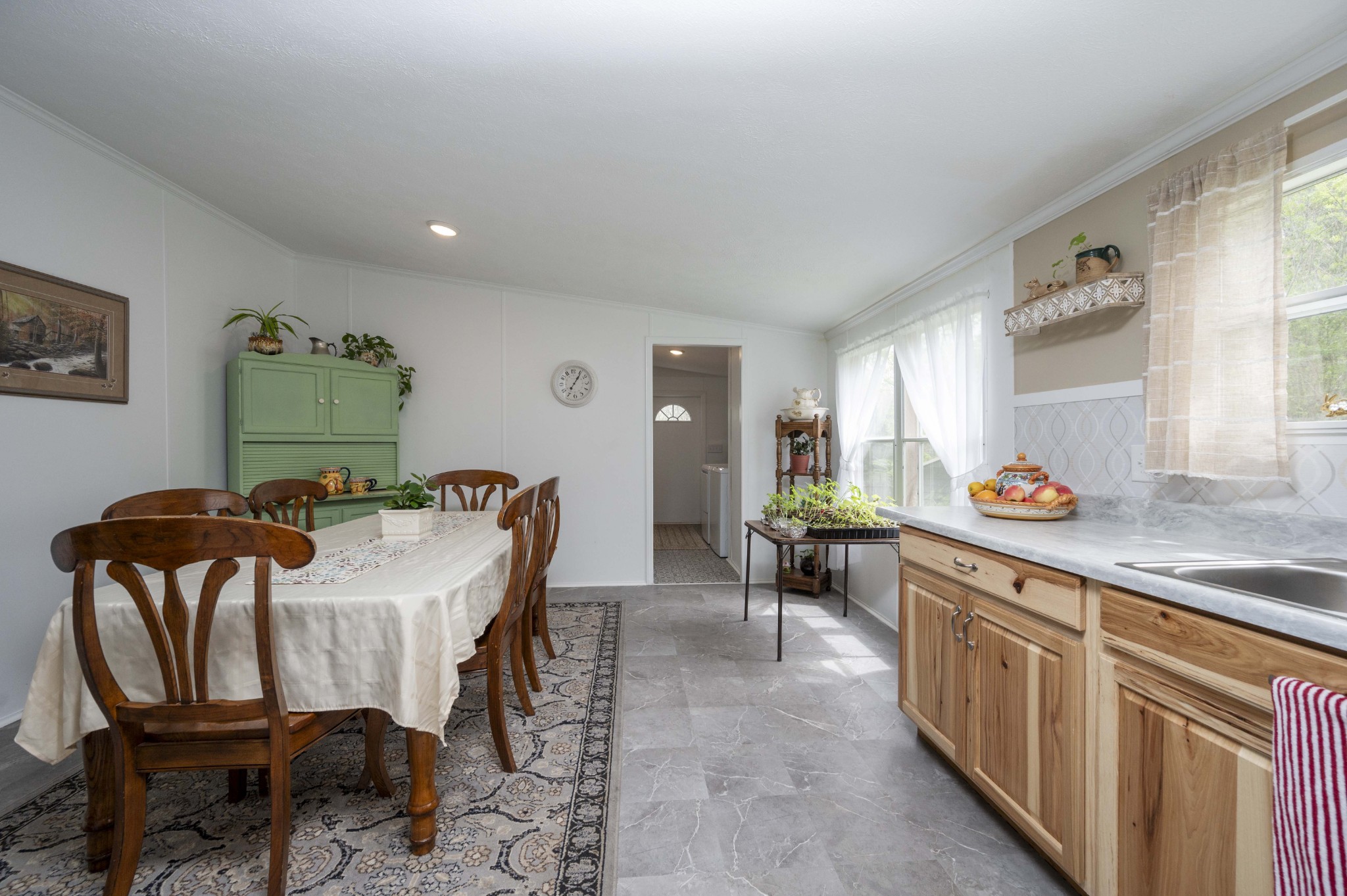 1822 Groveland Ridge Road Columbia, TN 38401 - Photo 18 of 48 a kitchen with stainless steel appliances granite countertop a stove a sink a dining table and chairs