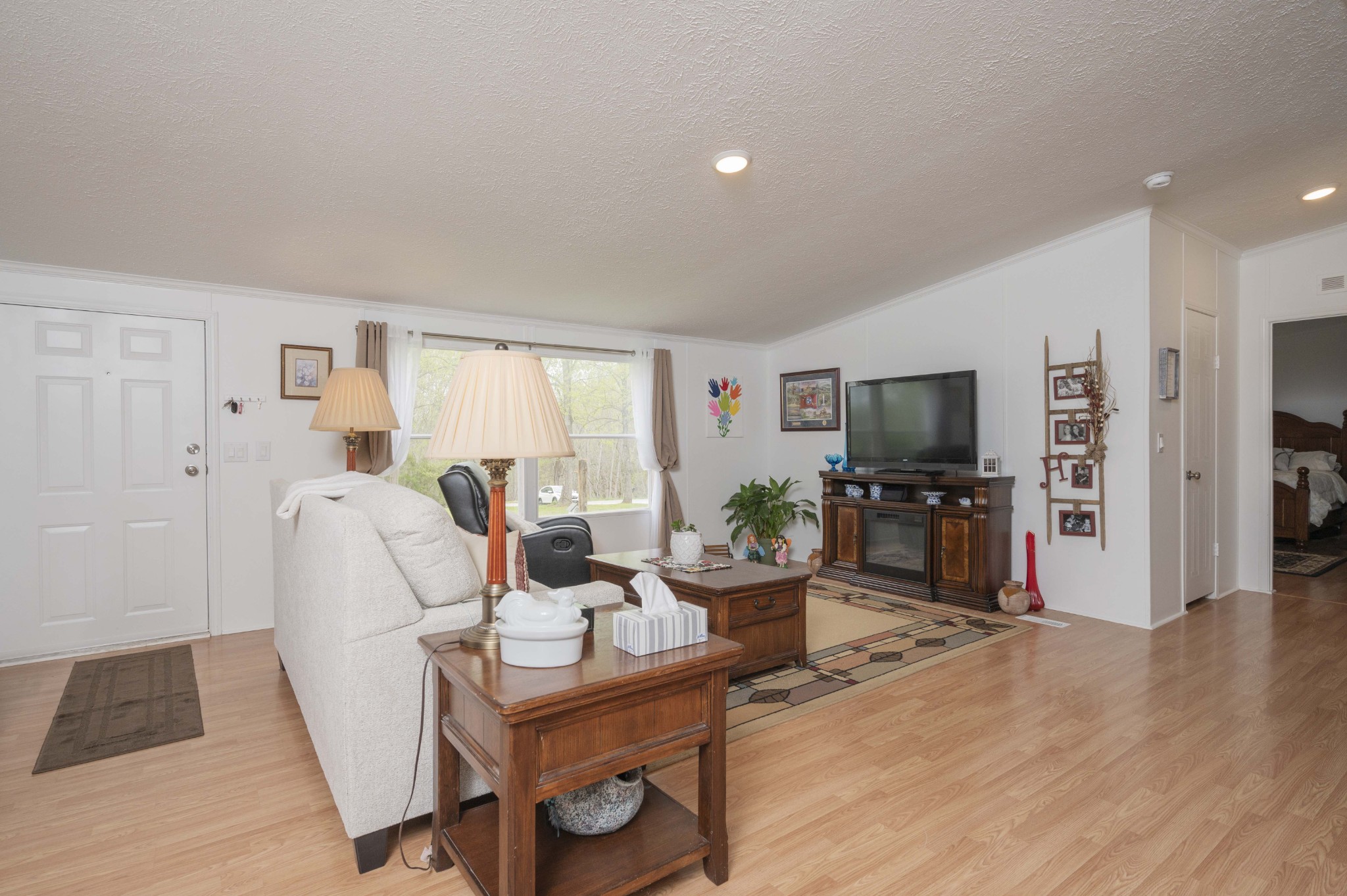 1822 Groveland Ridge Road Columbia, TN 38401 - Photo 4 of 48 a living room with furniture a flat screen tv and a refrigerator