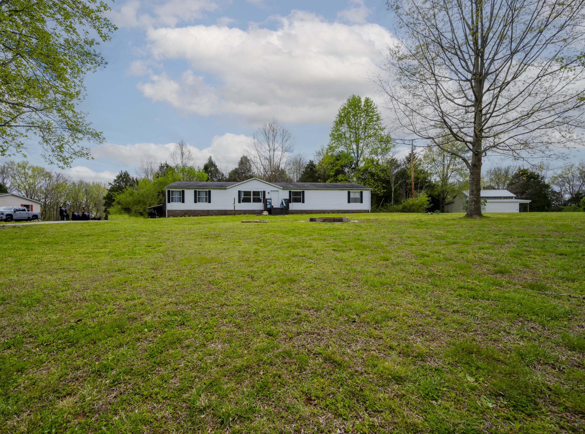 1822 Groveland Ridge Road Columbia, TN 38401 - Photo 47 of 48 a view of a building with a big yard and a large trees