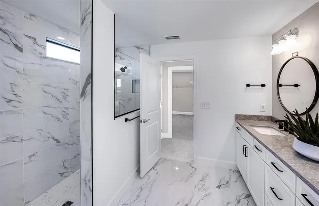 a spacious bathroom with a sink and a mirror