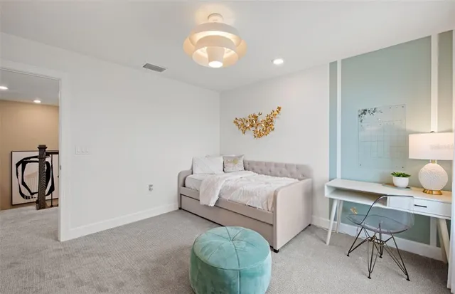 a bed room with a bed and a chair