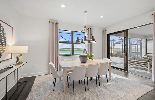 a view of a dining room with furniture window and wooden floor