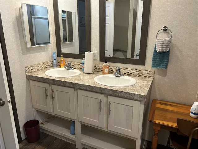 a view of a room with wooden floor and lounge chair