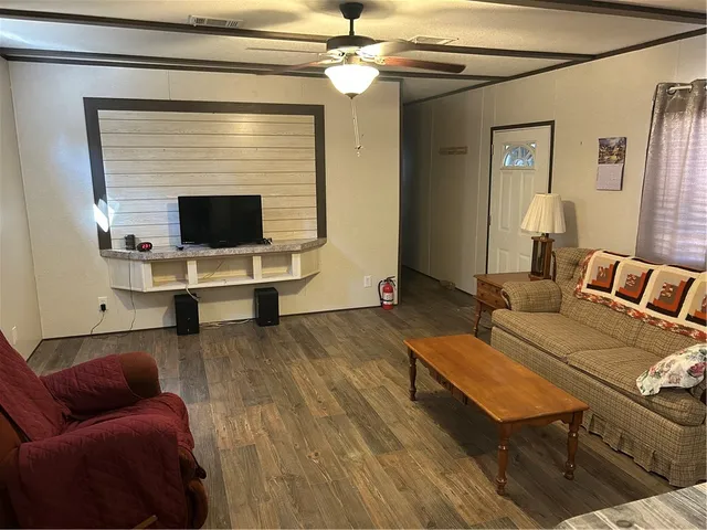a kitchen with stainless steel appliances granite countertop sink stove refrigerator and cabinets