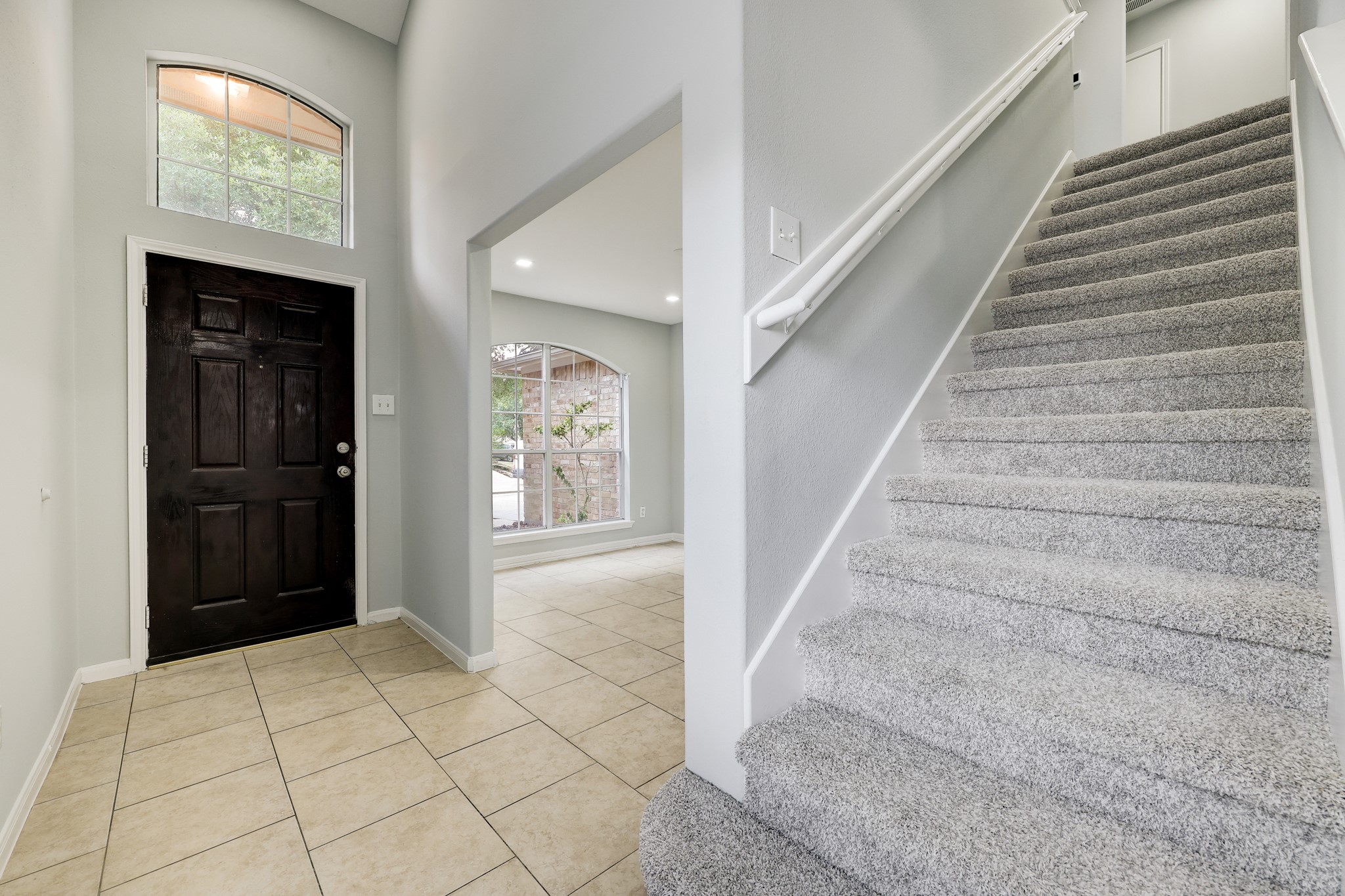 4906 Siros Isle Court Spring, TX 77389 - Photo 2 of 10 a view of staircase with white walls and windows