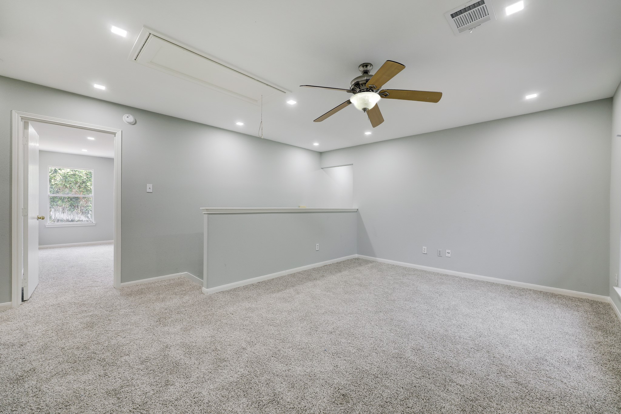 4906 Siros Isle Court Spring, TX 77389 - Photo 5 of 10 an empty room with windows and fan