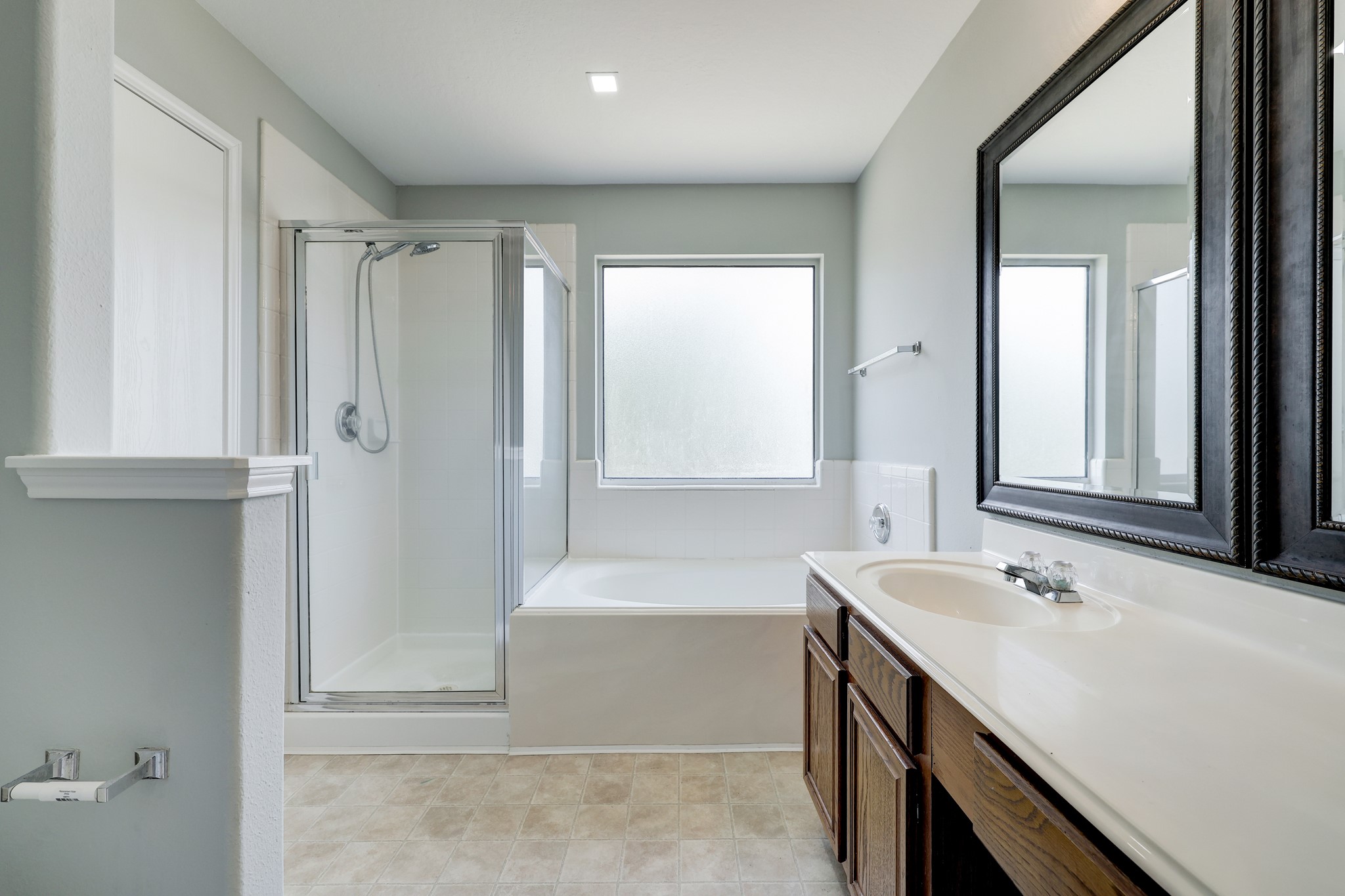 4906 Siros Isle Court Spring, TX 77389 - Photo 8 of 10 a bathroom with a tub sink and mirror