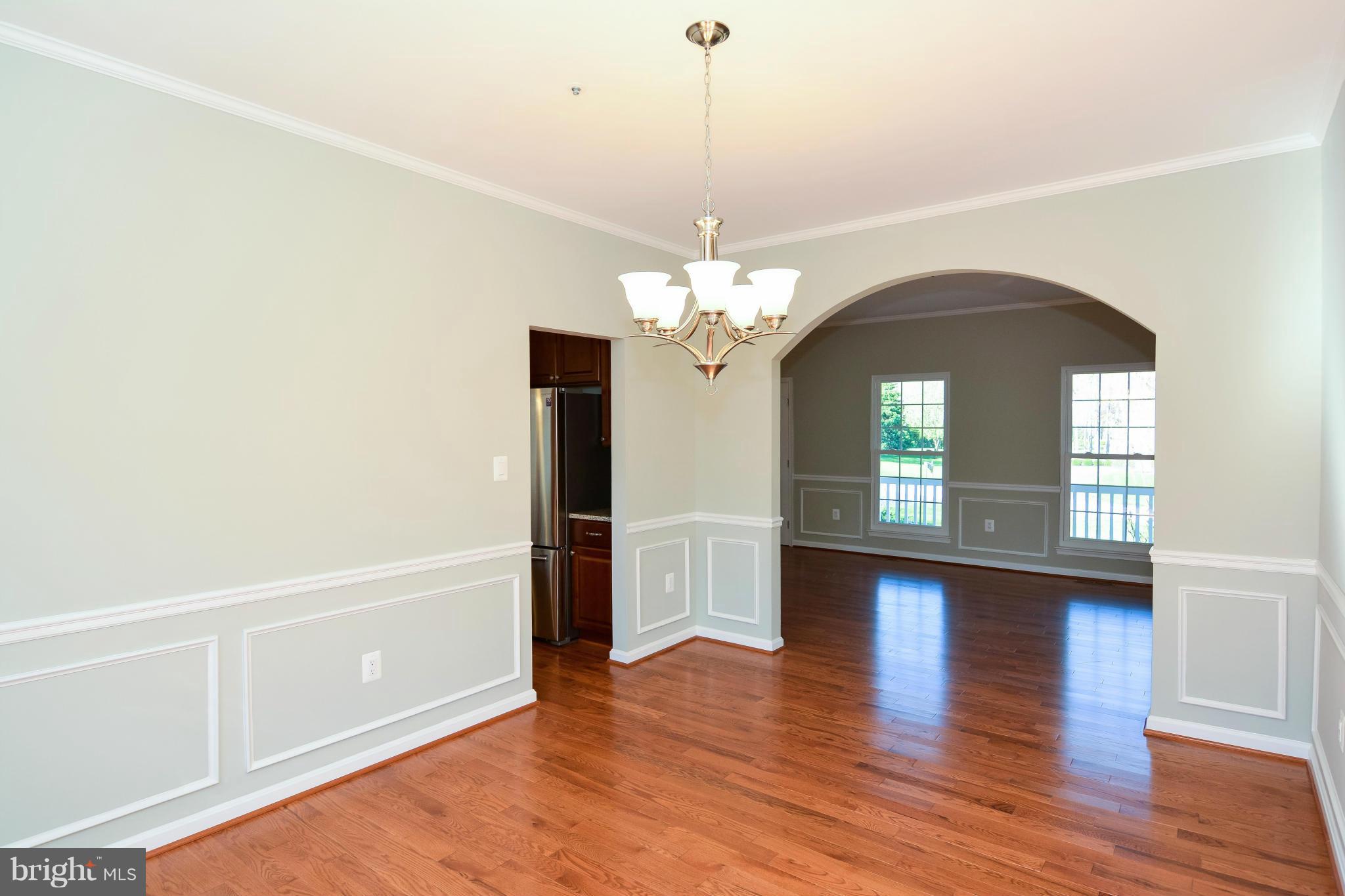 591 Small Reward Road Huntingtown, MD 20639 - Photo 13 of 30 a view of a livingroom with a chandelier wooden floor and a chandelier