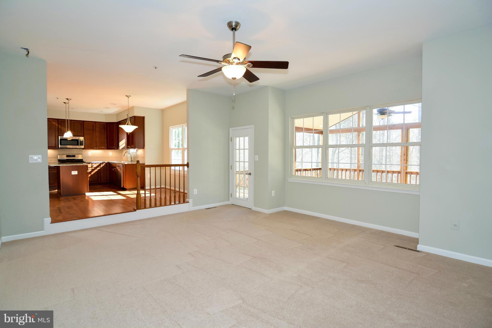 591 Small Reward Road Huntingtown, MD 20639 - Photo 15 of 30 a view of a livingroom with a ceiling fan and window