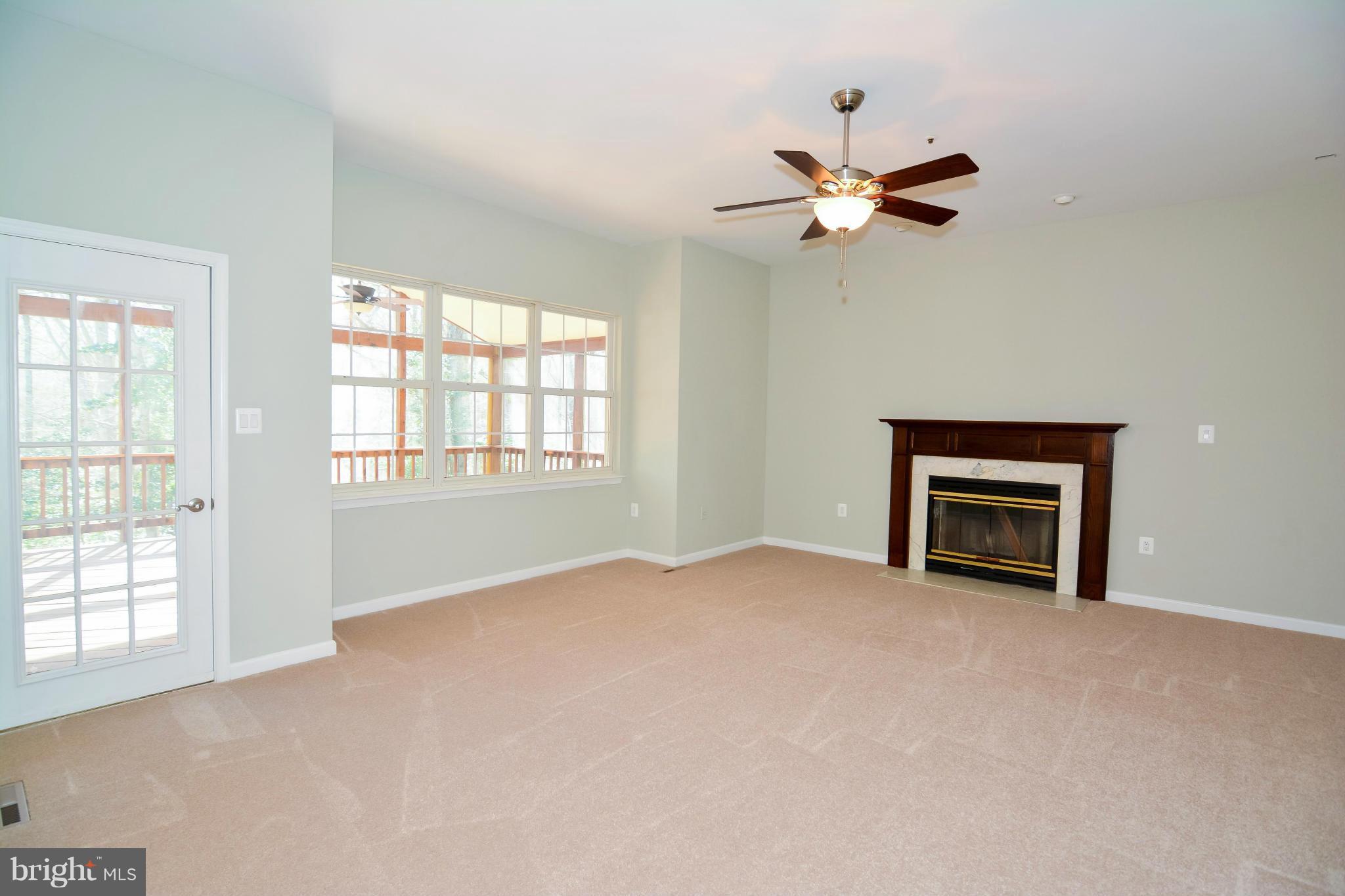 591 Small Reward Road Huntingtown, MD 20639 - Photo 16 of 30 an empty room with windows and fan