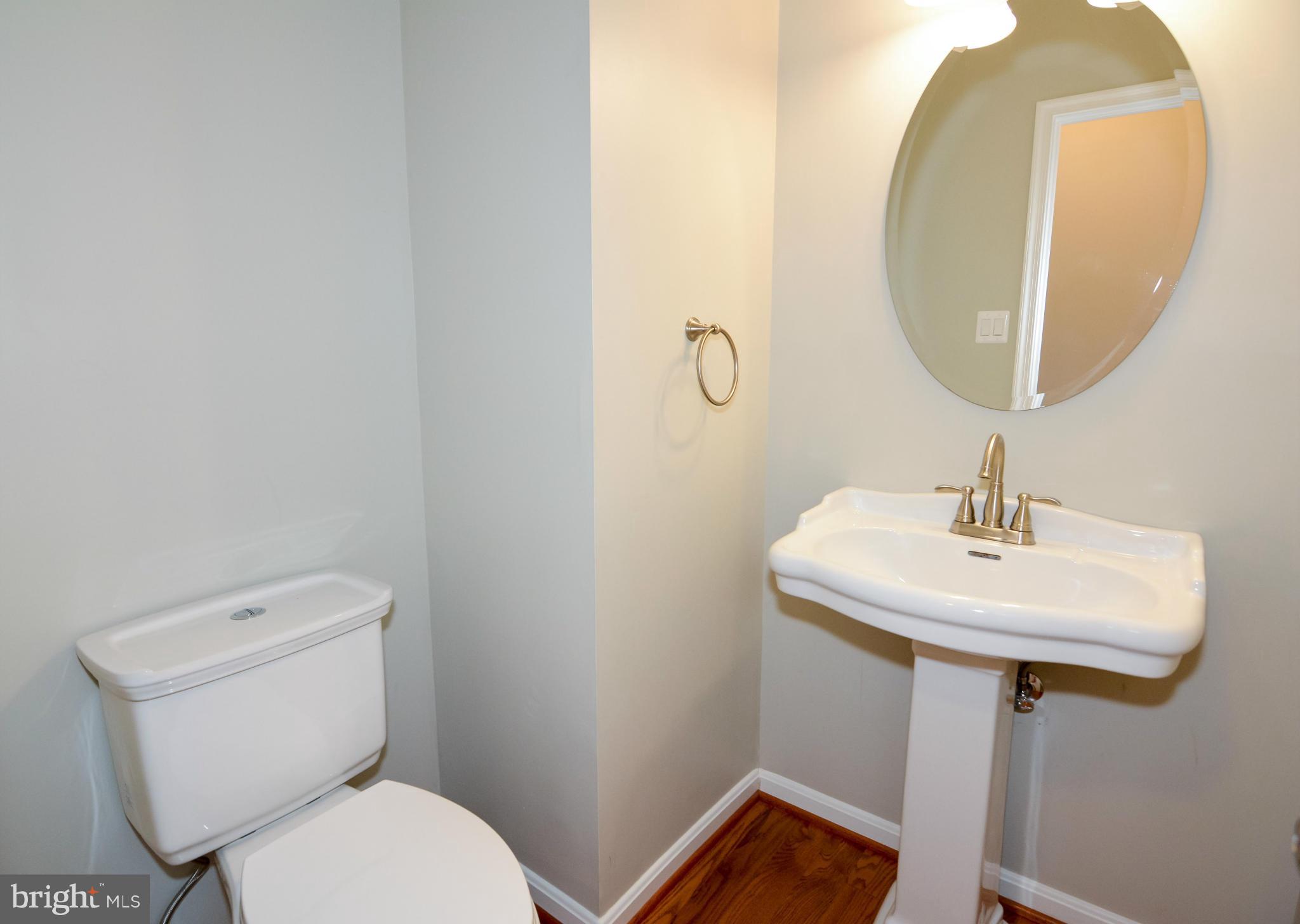 591 Small Reward Road Huntingtown, MD 20639 - Photo 17 of 30 a bathroom with a toilet sink and mirror