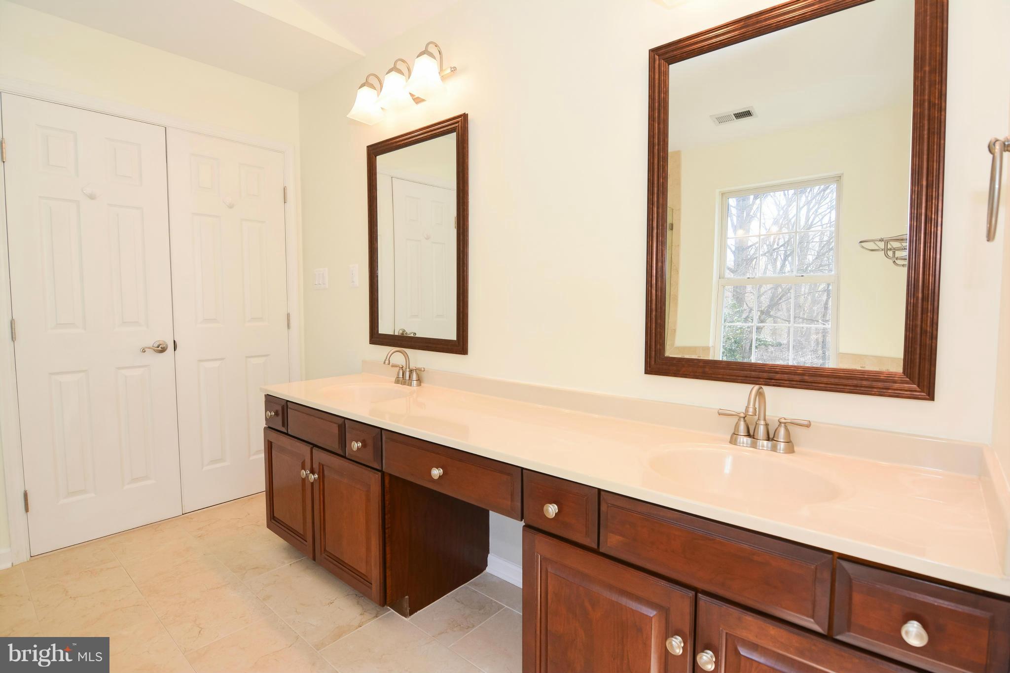 591 Small Reward Road Huntingtown, MD 20639 - Photo 23 of 30 a bathroom with a double vanity sink mirror and