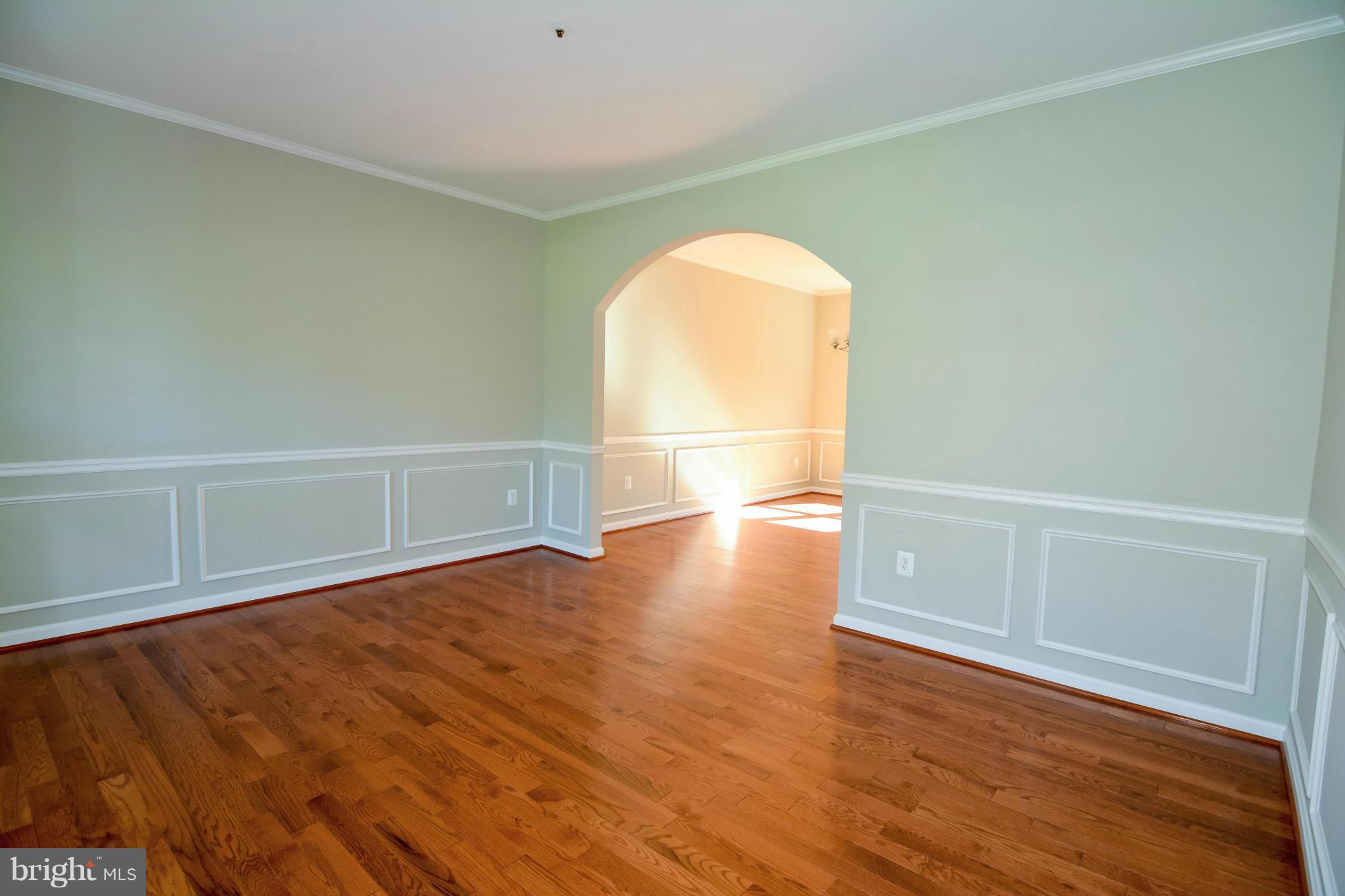 591 Small Reward Road Huntingtown, MD 20639 - Photo 8 of 30 a view of empty room with wooden floor and fan