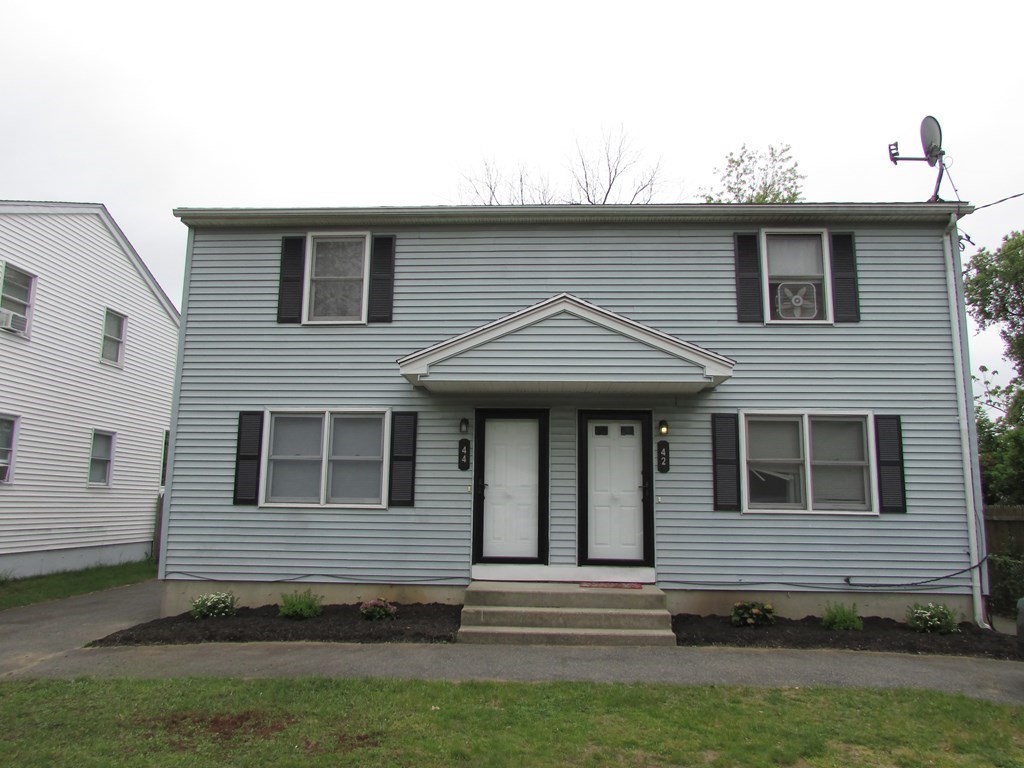 42-44 Wrentham Road Springfield, MA 01119 - Photo 1 of 31 a front view of a house with a garden