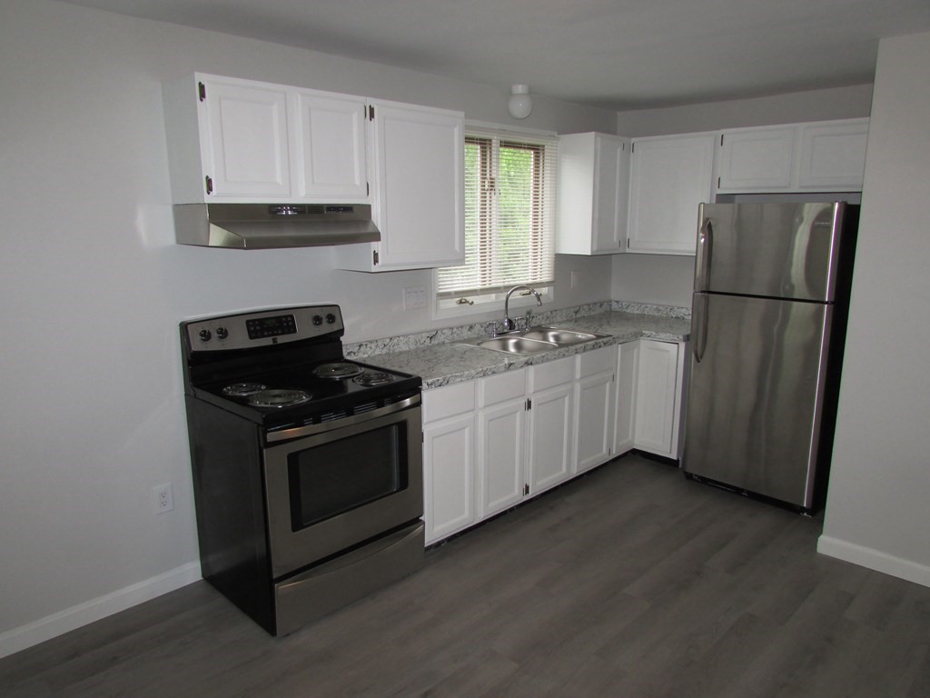 42-44 Wrentham Road Springfield, MA 01119 - Photo 11 of 31 a kitchen with a sink stove and refrigerator