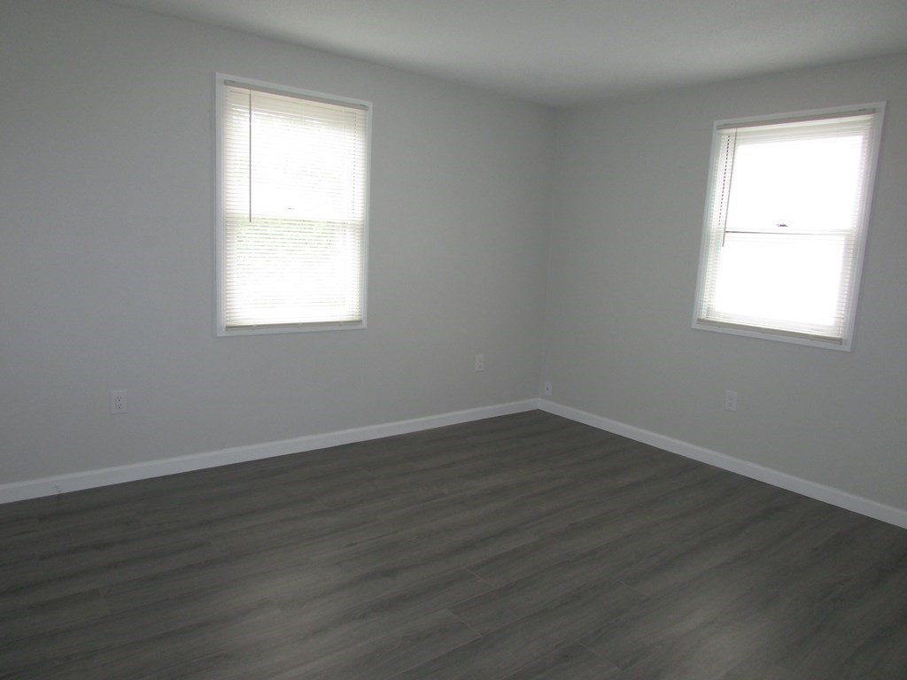 42-44 Wrentham Road Springfield, MA 01119 - Photo 21 of 31 an empty room with wooden floor and windows