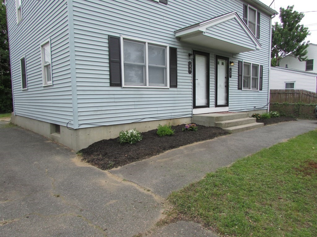 42-44 Wrentham Road Springfield, MA 01119 - Photo 6 of 31 a front view of a house with garden