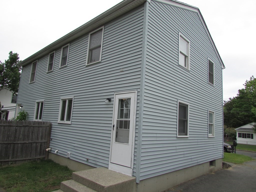 42-44 Wrentham Road Springfield, MA 01119 - Photo 8 of 31 a view of a house with a yard and garage