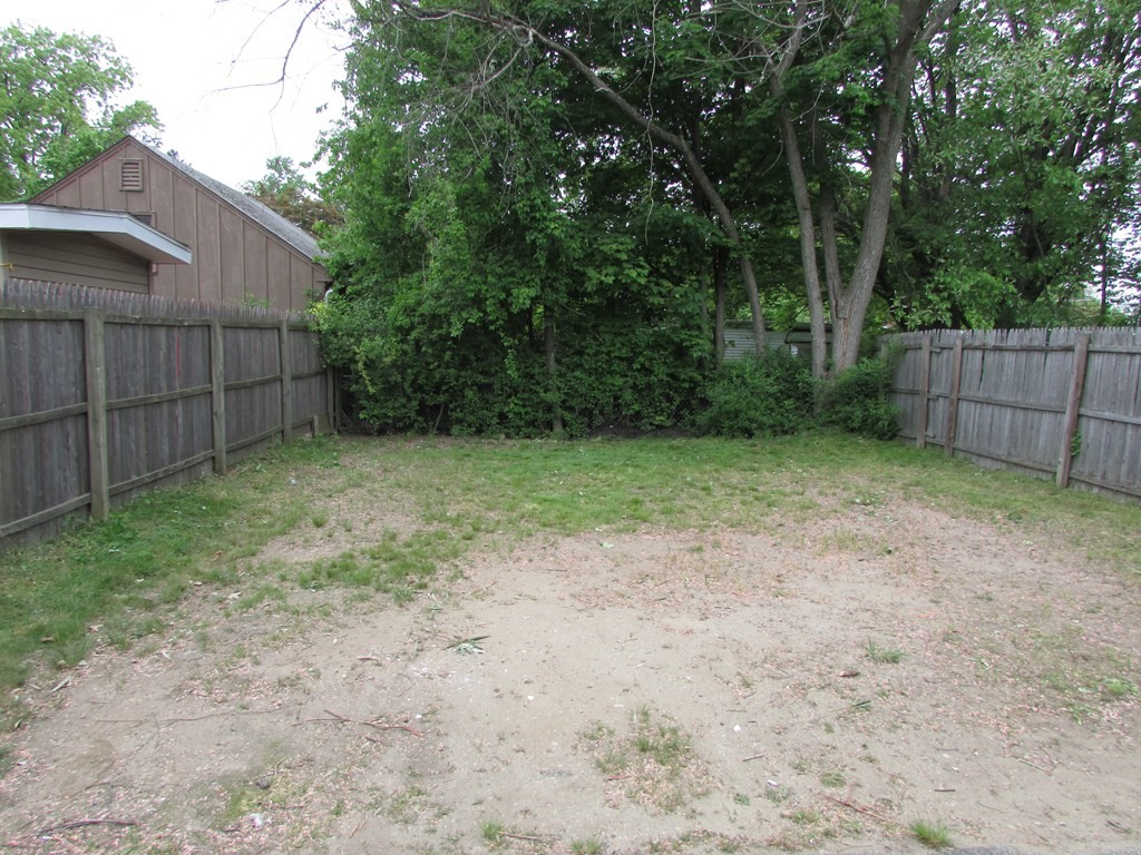 42-44 Wrentham Road Springfield, MA 01119 - Photo 9 of 31 a view of a backyard with wooden fence