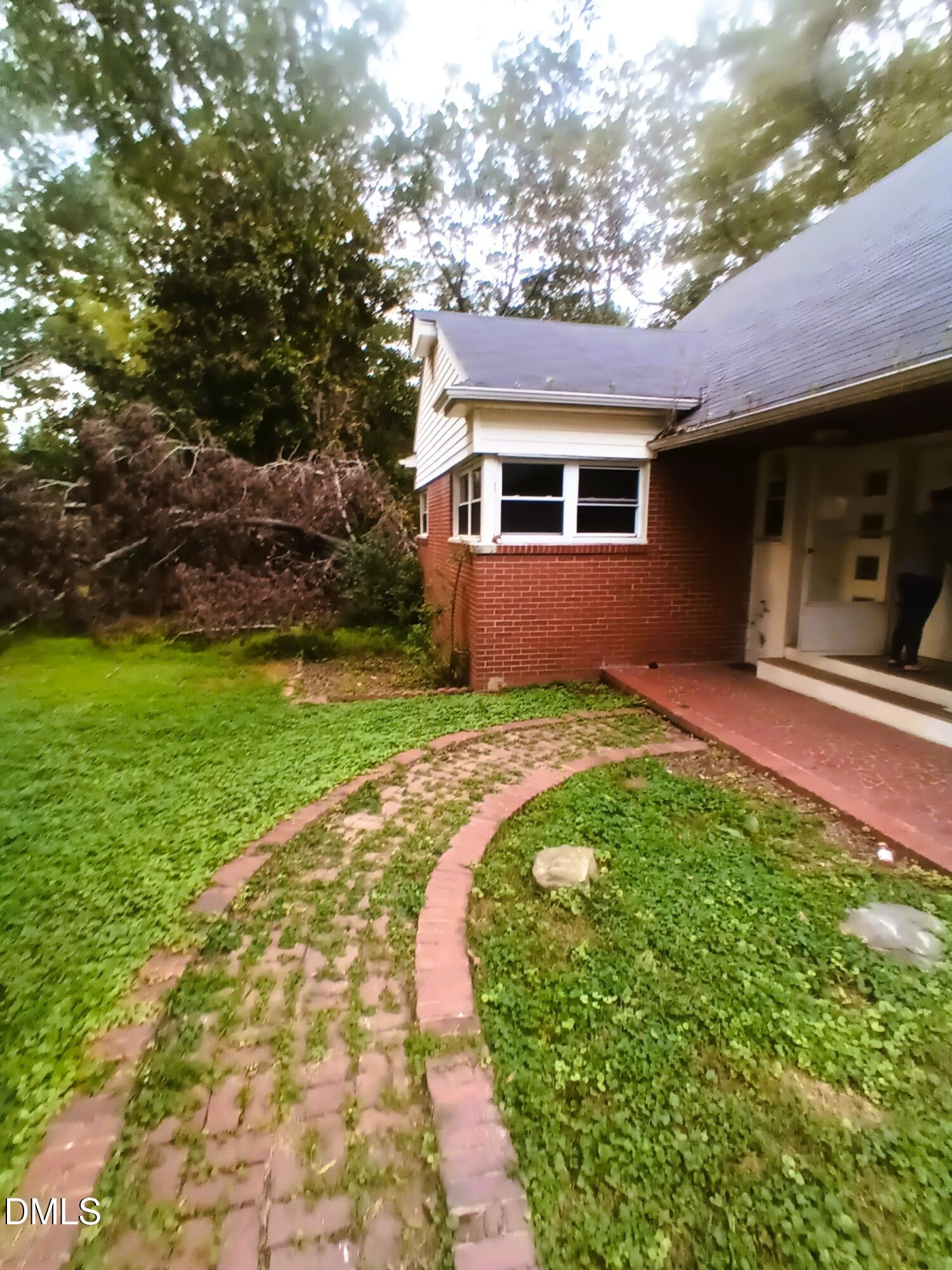 7856 Boston Road Roxboro, NC 27574 - Photo 3 of 18 a front view of a house with garden