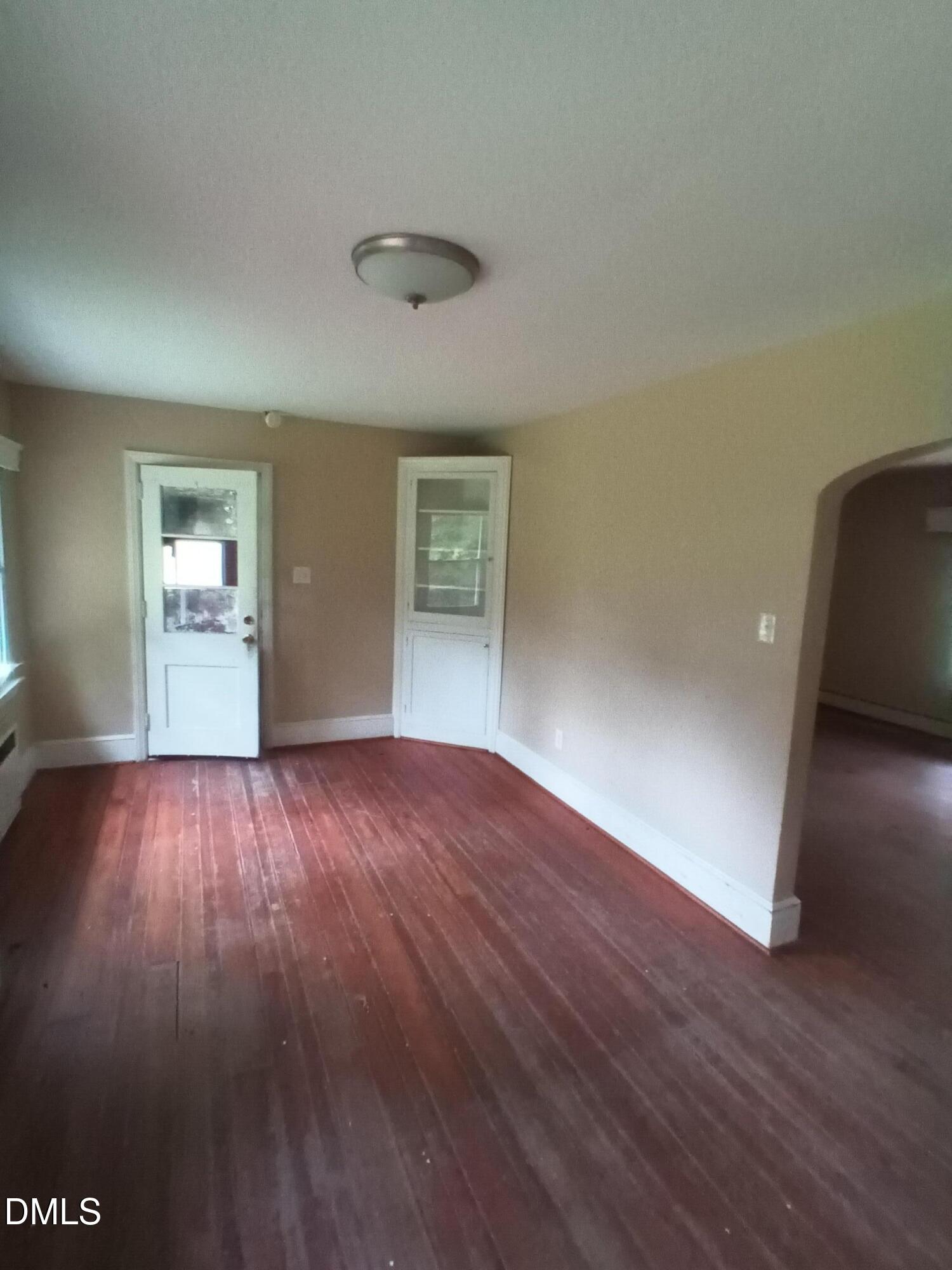7856 Boston Road Roxboro, NC 27574 - Photo 4 of 18 an empty room with wooden floor and windows
