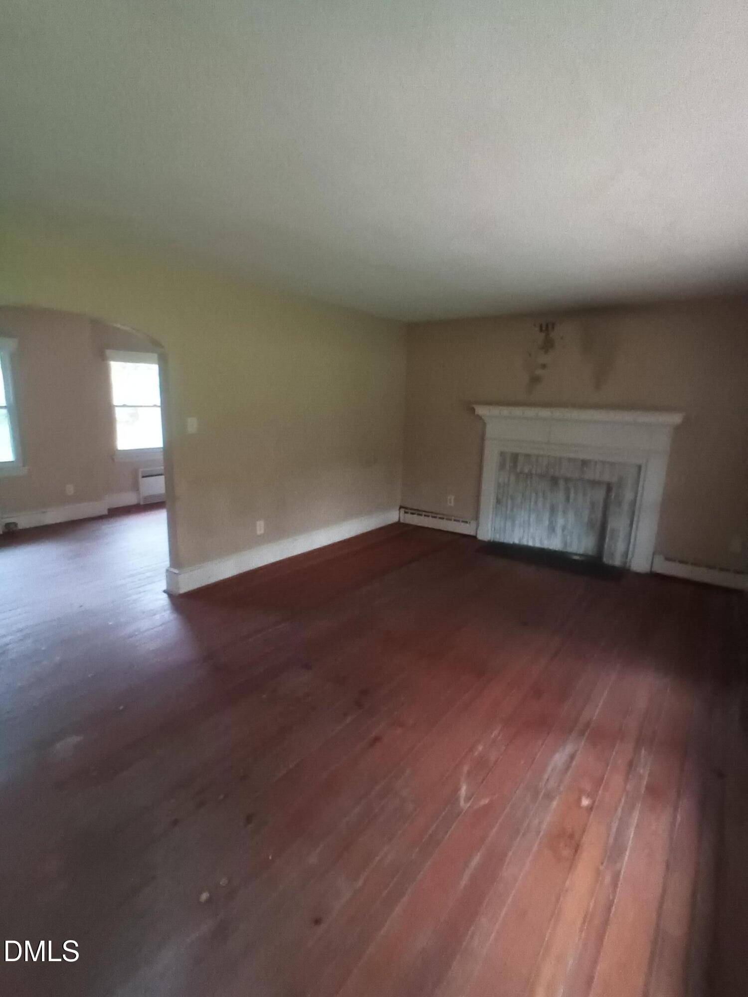 7856 Boston Road Roxboro, NC 27574 - Photo 5 of 18 a view of an empty room with wooden floor and a window