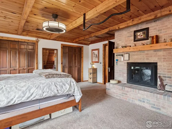 a spacious bedroom with a bed and a fireplace