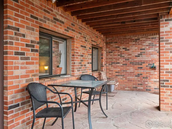a backyard of a house with table and chairs