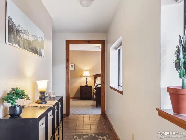 a view of a hallway to a livingroom and a couch