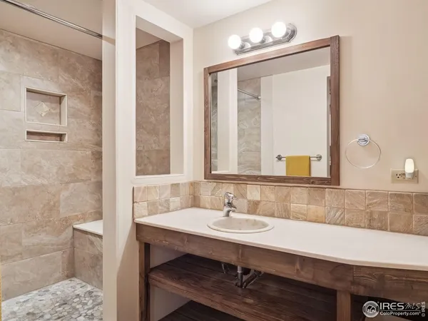 a bathroom with a sink a light fixture and a mirror