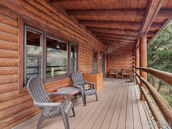 a balcony with wooden floor and outdoor seating