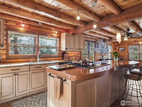 a view of a kitchen with stainless steel appliances granite countertop a sink and cabinets