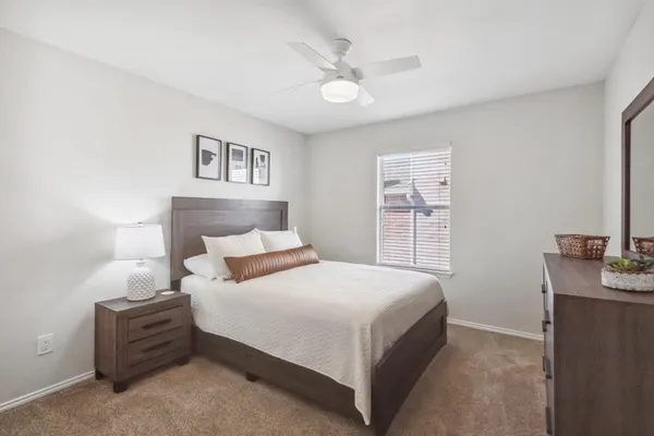 a bedroom with a bed and a desk